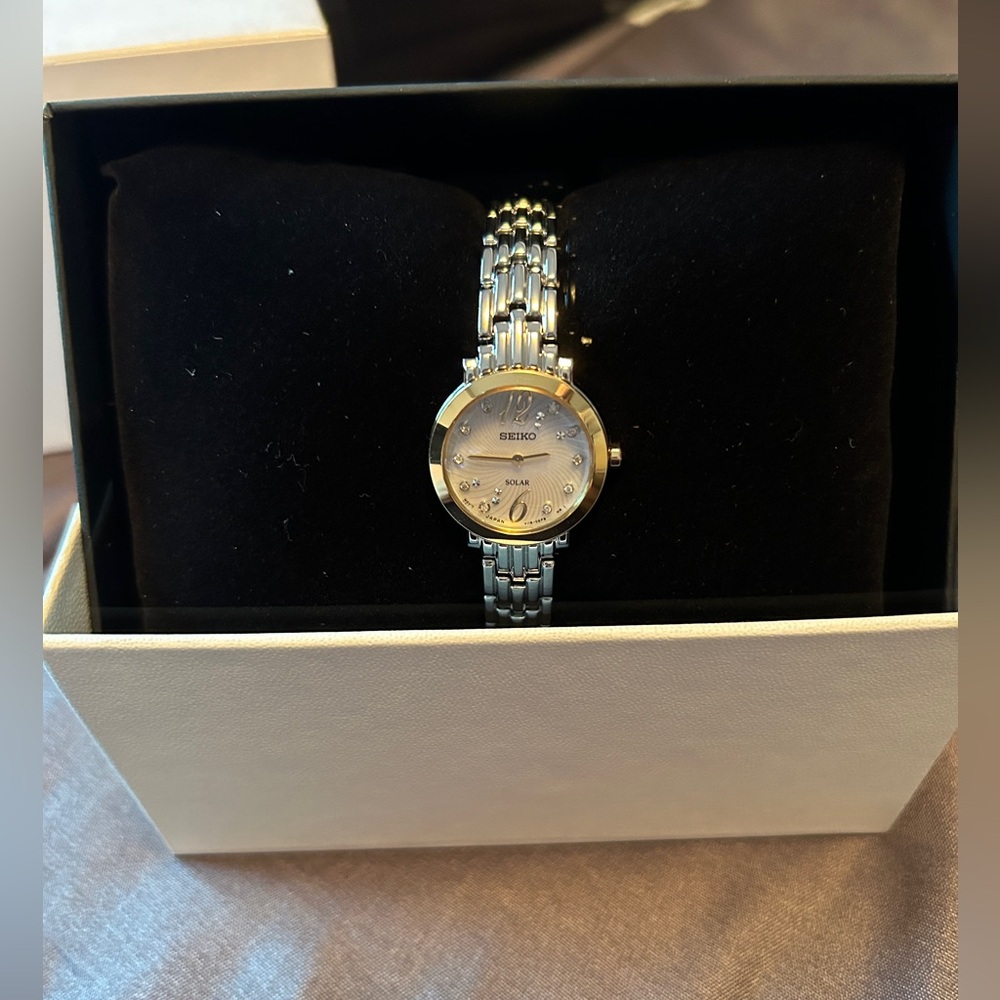Seiko women’s watch with mother of pearl face. Silver tone. New in box